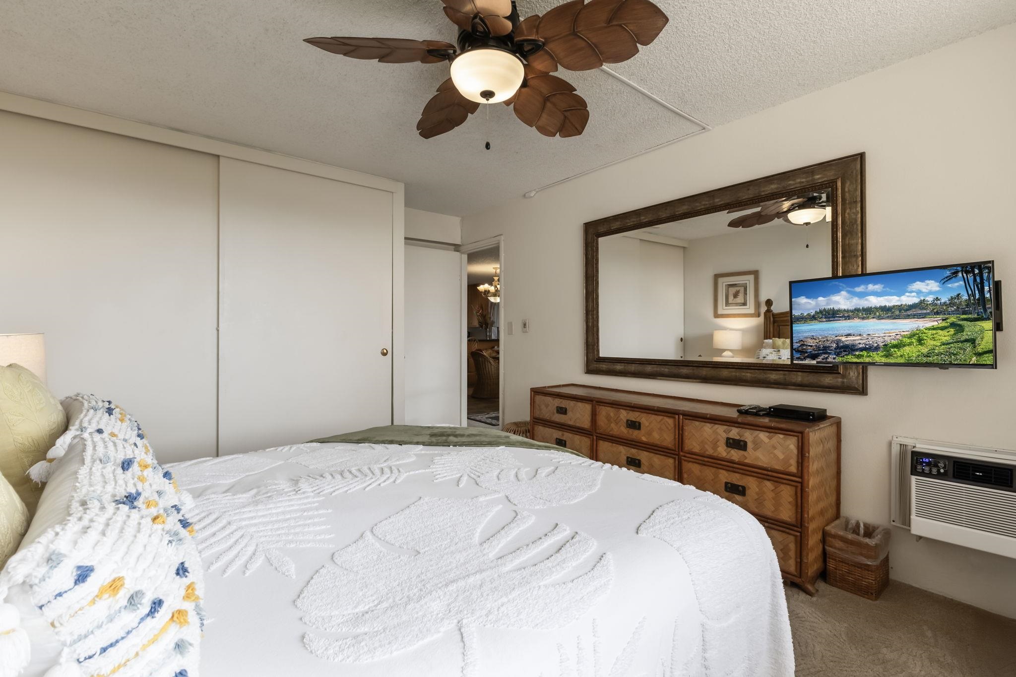 2695 South Kihei Road, Unit 4301 Kihei, HI 96753 - Photo 15 of 45 a bedroom with a bed and a chandelier
