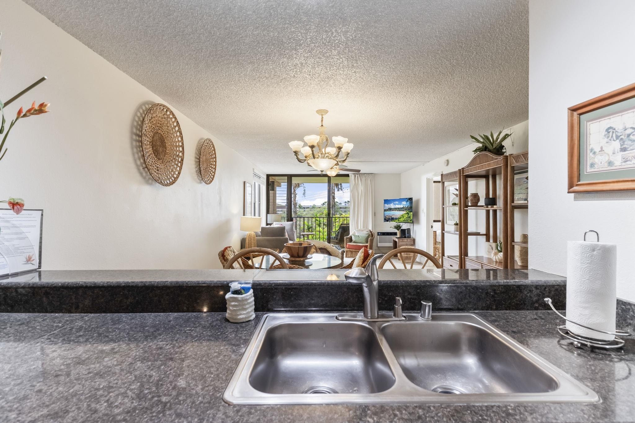 2695 South Kihei Road, Unit 4301 Kihei, HI 96753 - Photo 19 of 45 a kitchen with a sink a faucet a chandelier and living room