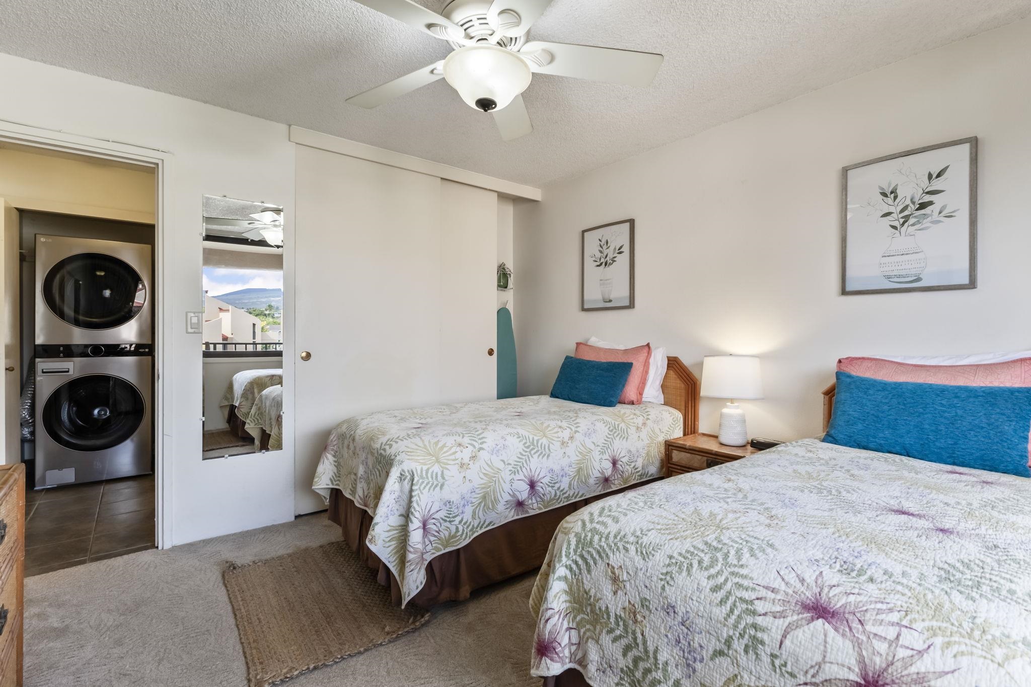 2695 South Kihei Road, Unit 4301 Kihei, HI 96753 - Photo 22 of 45 a bedroom with two beds and painting on the wall