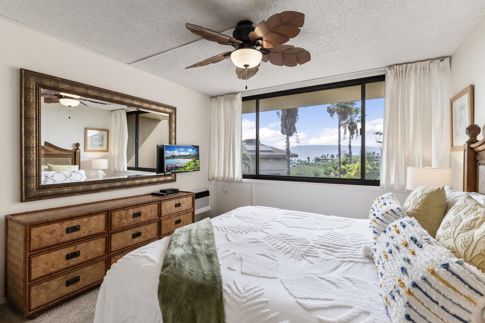 2695 South Kihei Road, Unit 4301 Kihei, HI 96753 - Photo 8 of 45 a bedroom with a large bed and a large window