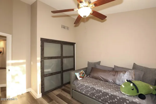 a dining room with furniture and a potted plant