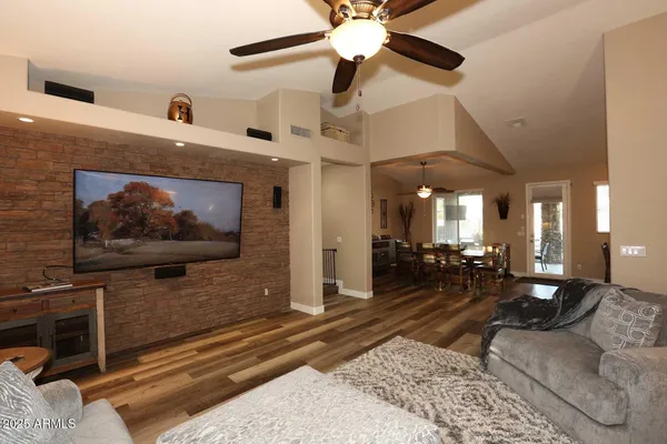 a living room with furniture and a wooden floor