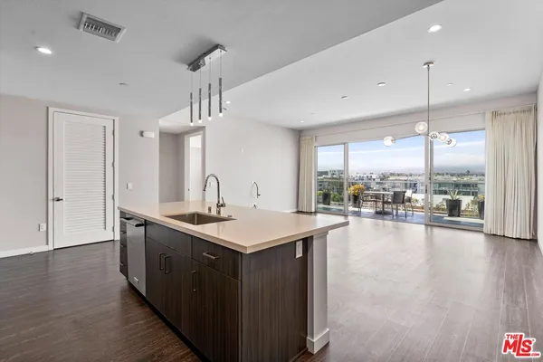 an open kitchen with a sink and dish washer