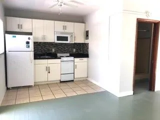 a kitchen with stainless steel appliances a refrigerator sink and microwave
