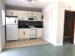 a kitchen with stainless steel appliances a refrigerator a stove a sink a counter top space and cabinets