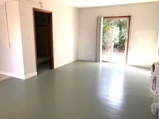 a view of an empty room with glass door