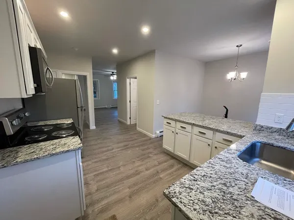a view of kitchen with sink microwave and refrigerator