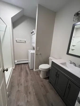 a view of entryway and hallway with bathroom