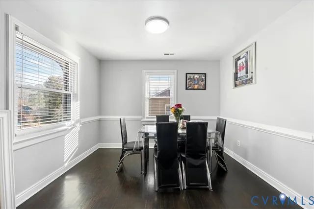 a view of a dining room with furniture and wooden floor