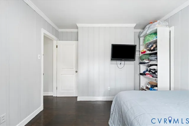 a view of a room with wooden floor and a window