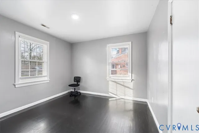 a hall way with a furniture and wooden floor