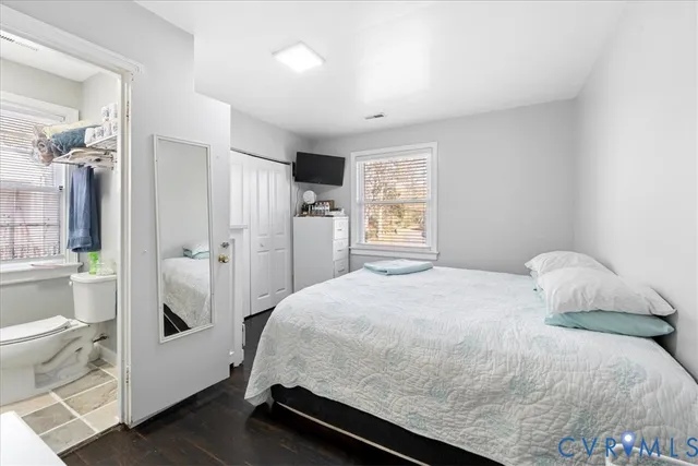 a bedroom with a bed and a closet