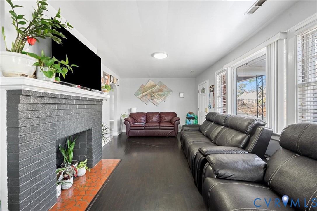 3930 Patsy Ann Drive Richmond, VA 23234 - Photo 10 of 36 Living area with a fireplace and dark wood-type fl