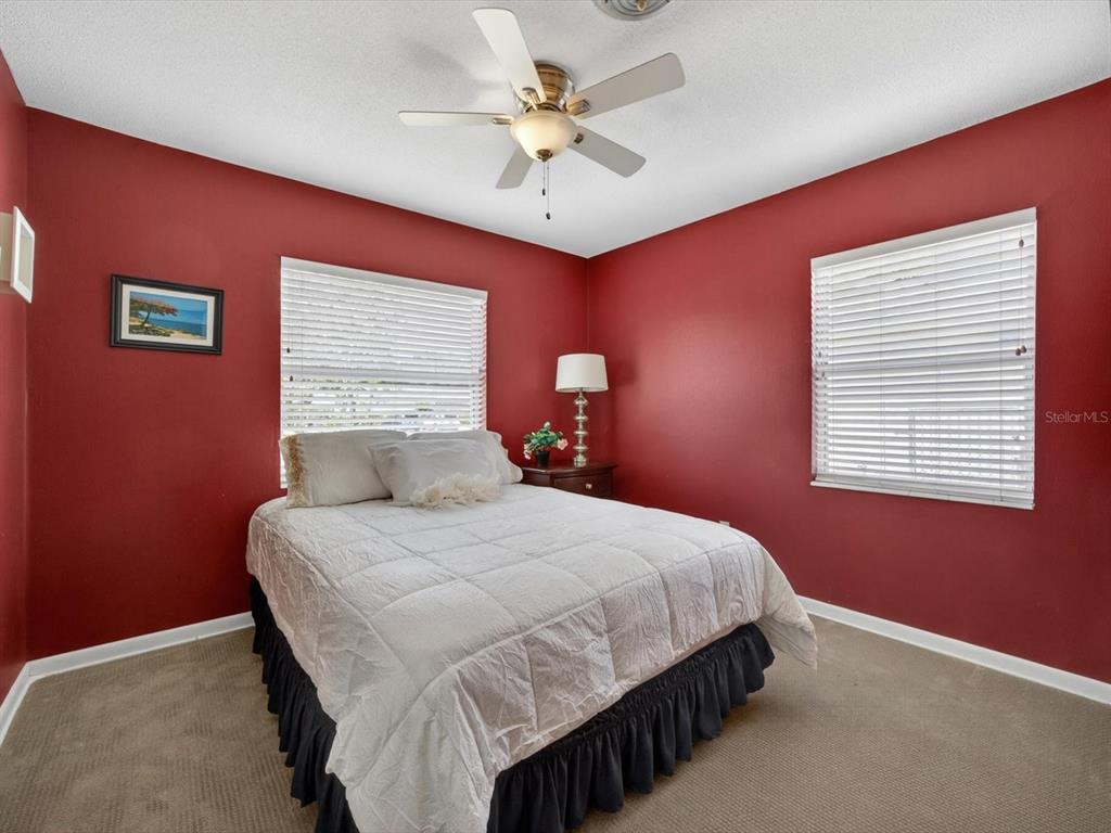 2803 Banchory Road Winter Park, FL 32792 - Photo 17 of 31 a bedroom with a bed chandelier and a window