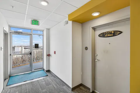 a view of a hallway with wooden floor