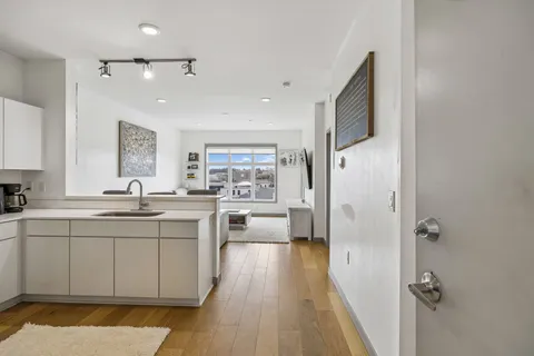 a spacious bathroom with a double vanity sink a mirror and a shower
