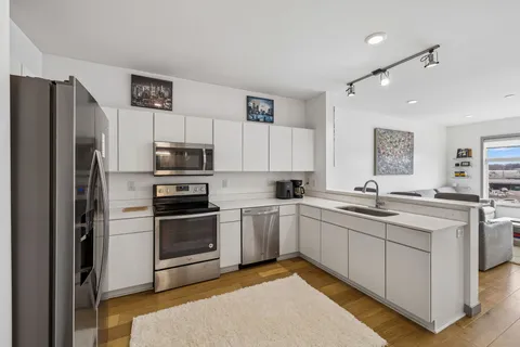 a kitchen with a sink stainless steel appliances and cabinets