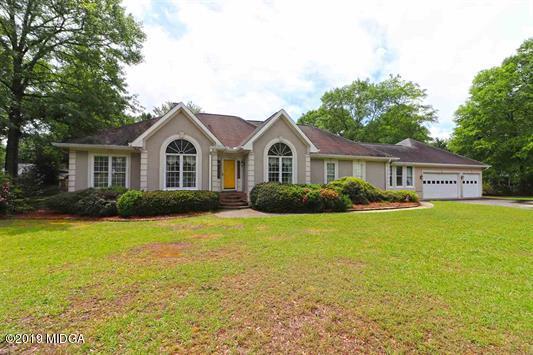 105 Wilton Circle Perry, GA 31069 - Photo 1 of 35 a front view of a house with a garden and porch