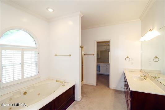 105 Wilton Circle Perry, GA 31069 - Photo 17 of 35 a bathroom with a tub sink and a mirror