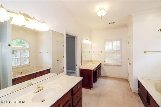 105 Wilton Circle Perry, GA 31069 - Photo 18 of 35 a spacious bathroom with a granite countertop sink and a mirror