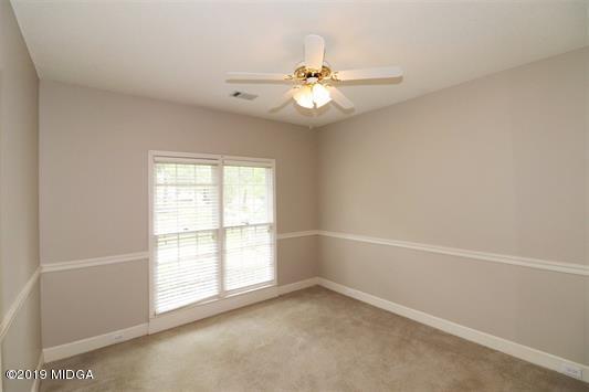 105 Wilton Circle Perry, GA 31069 - Photo 23 of 35 an empty room with windows and fan