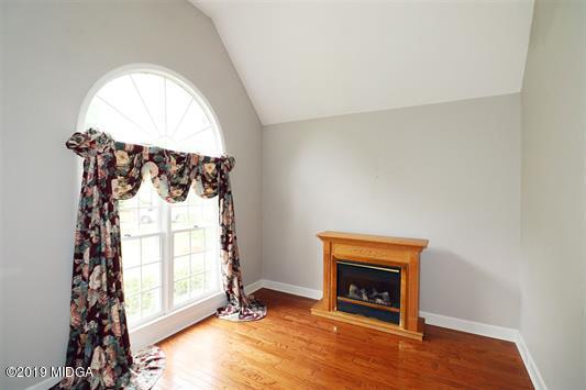 105 Wilton Circle Perry, GA 31069 - Photo 5 of 35 an empty room with windows fire place and a fireplace