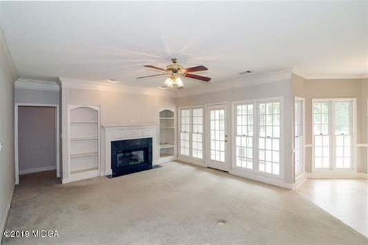 105 Wilton Circle Perry, GA 31069 - Photo 7 of 35 a view of an empty room with a fireplace and a window