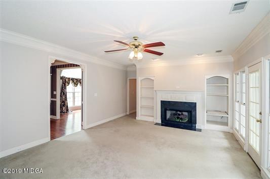 105 Wilton Circle Perry, GA 31069 - Photo 8 of 35 a view of an empty room with a fireplace and a window