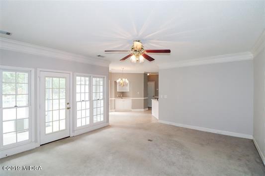 105 Wilton Circle Perry, GA 31069 - Photo 9 of 35 an empty room with chandelier fan and windows