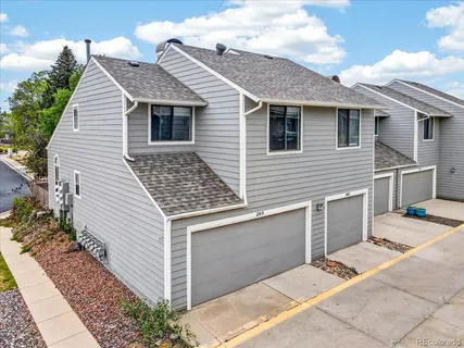 a view of house with backyard space and garden