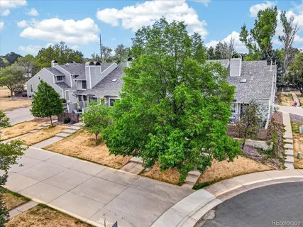 an aerial view of residential houses with outdoor space and swimming pool