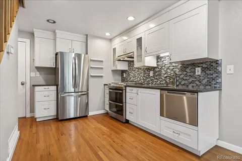 a kitchen with stainless steel appliances granite countertop a stove and a refrigerator
