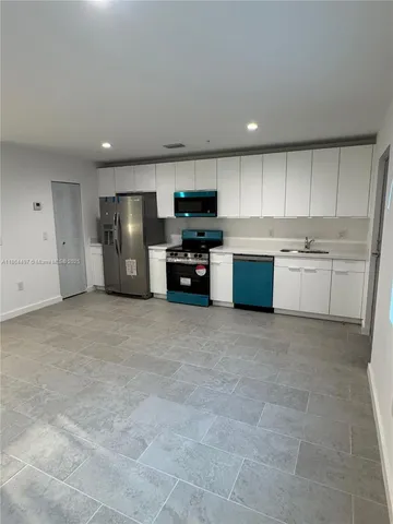a kitchen with a table and chairs in it