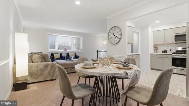 a dining room with furniture a clock and a rug