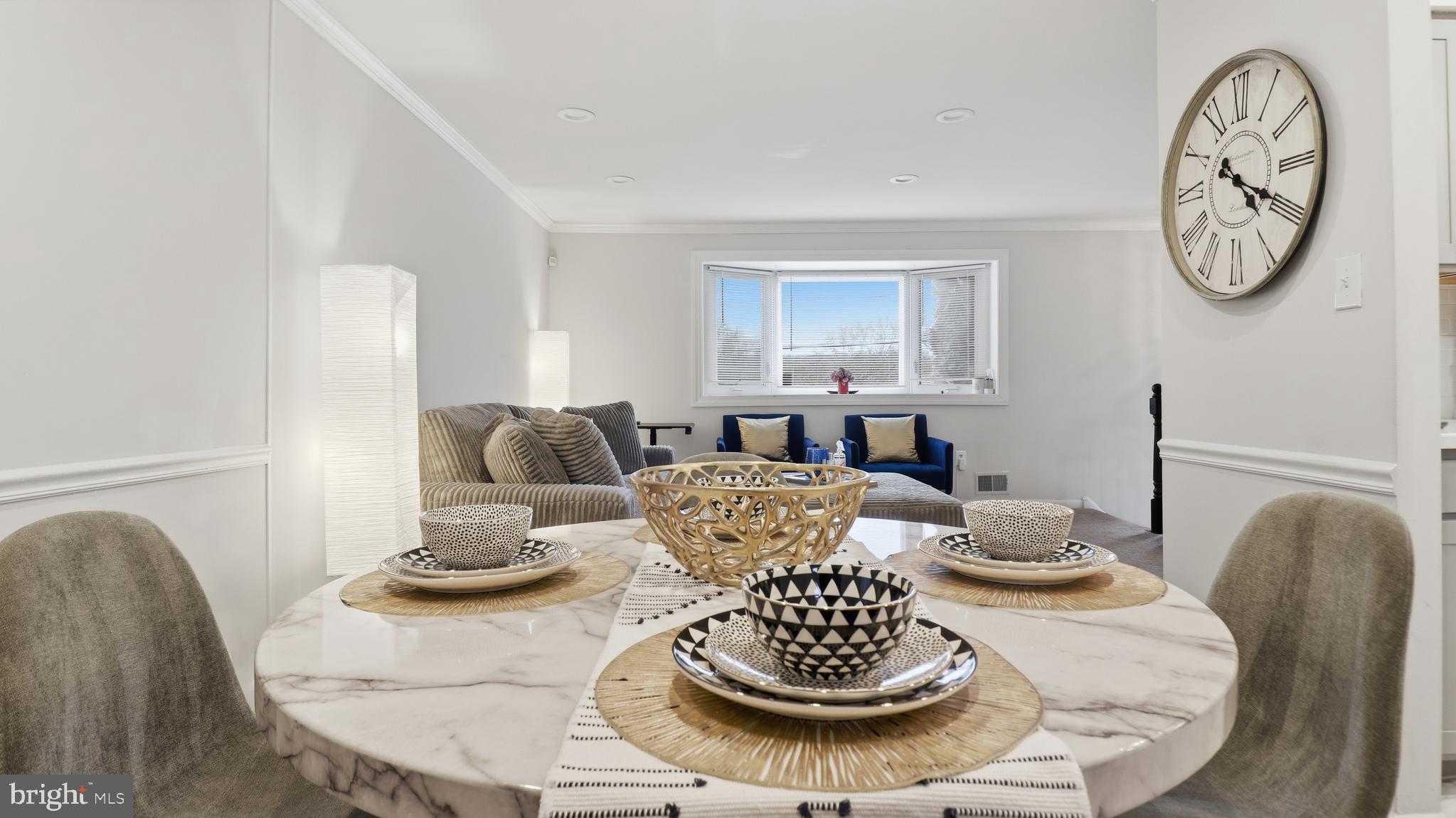 6710 Eilerson Street Clinton, MD 20735 - Photo 12 of 58 a dining room with furniture a clock and a rug