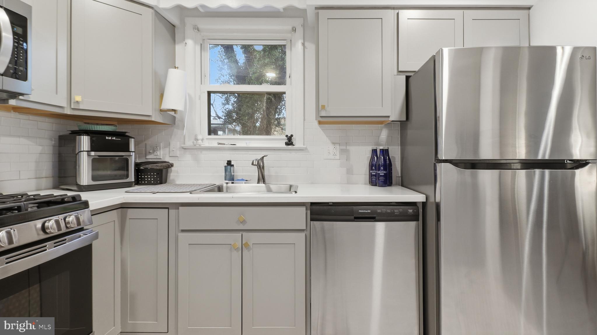 6710 Eilerson Street Clinton, MD 20735 - Photo 16 of 58 a kitchen with stainless steel appliances granite countertop a refrigerator sink and stove