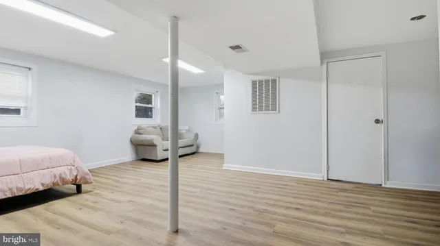 a living room with furniture a rug and a window
