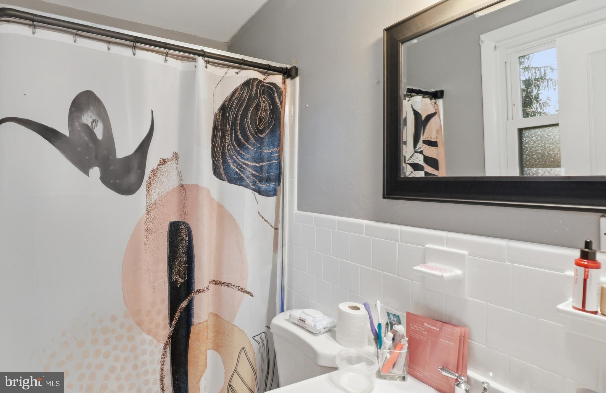 6710 Eilerson Street Clinton, MD 20735 - Photo 27 of 58 a bathroom with a bathtub and a window