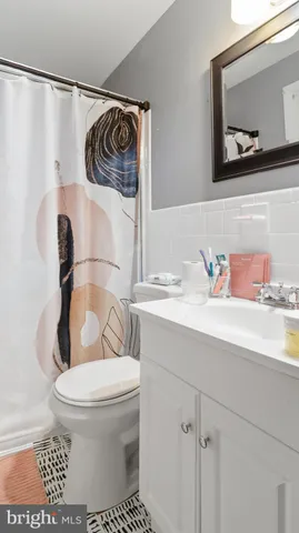 a spacious bedroom with a large bed and a chandelier