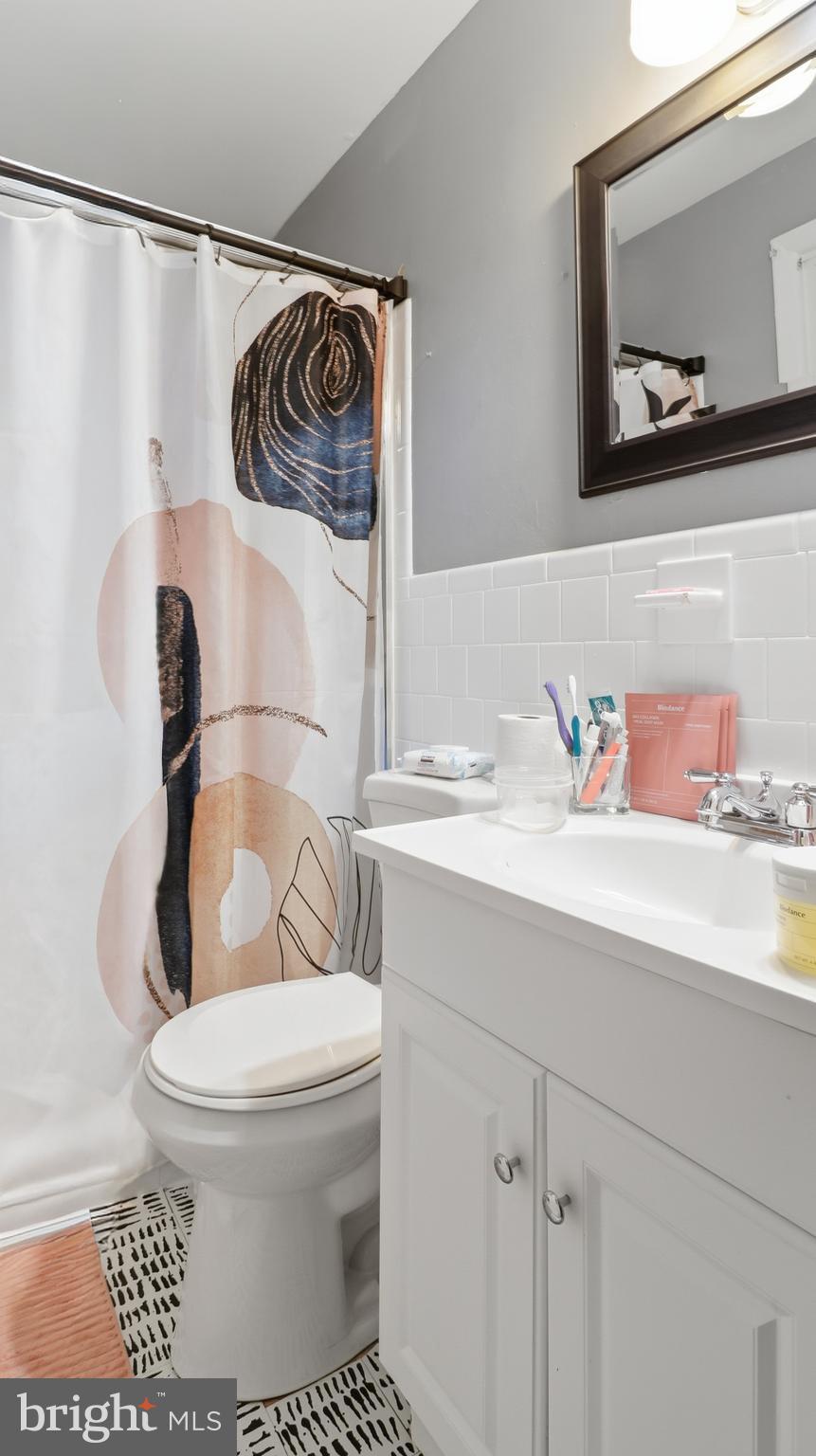 6710 Eilerson Street Clinton, MD 20735 - Photo 28 of 58 a bathroom with a toilet a sink and mirror