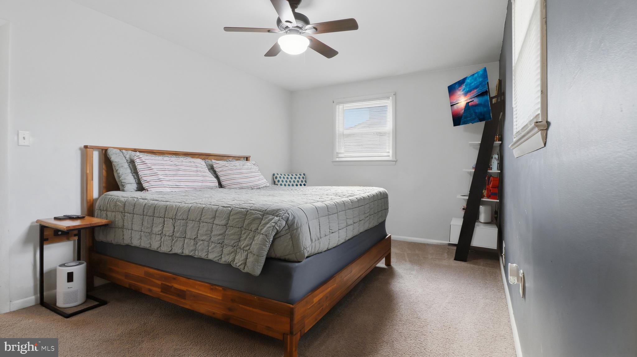 6710 Eilerson Street Clinton, MD 20735 - Photo 29 of 58 a bedroom with a bed and a chandelier