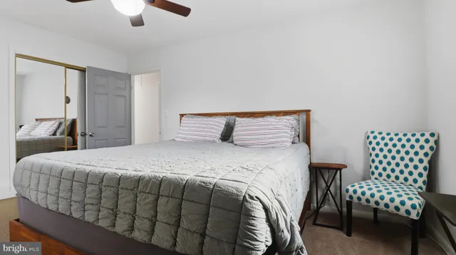 a bedroom with a bed and a couch