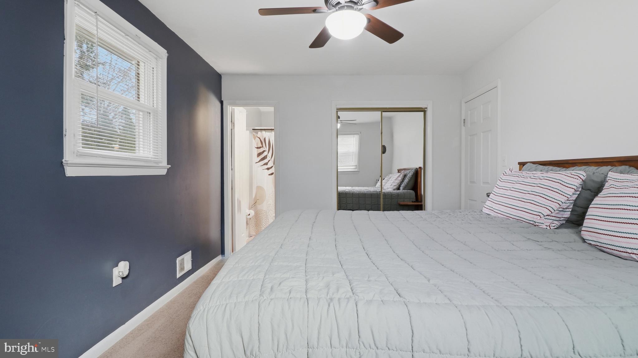 6710 Eilerson Street Clinton, MD 20735 - Photo 31 of 58 a spacious bedroom with a large bed and a chandelier