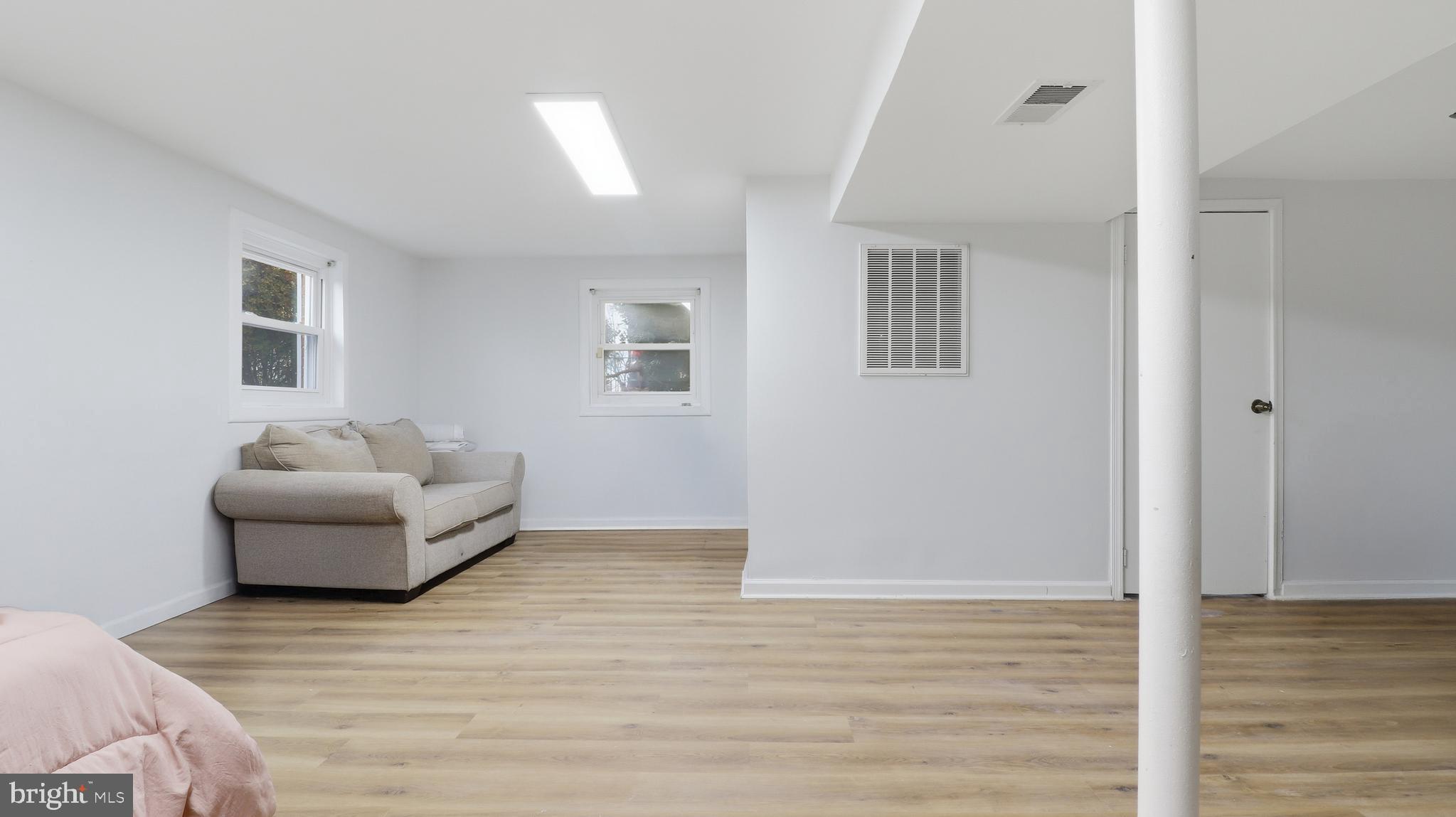 6710 Eilerson Street Clinton, MD 20735 - Photo 32 of 58 a living room with furniture and a wooden floor