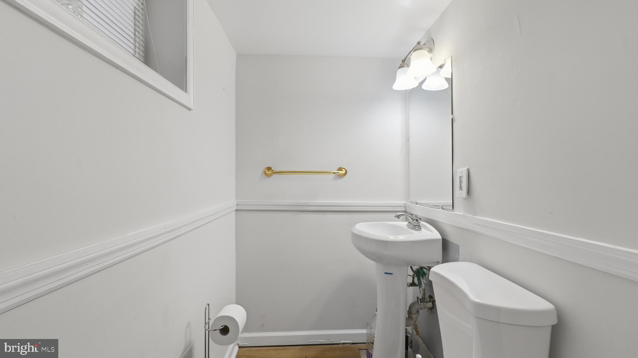 6710 Eilerson Street Clinton, MD 20735 - Photo 35 of 58 a bathroom with a sink a toilet and a mirror