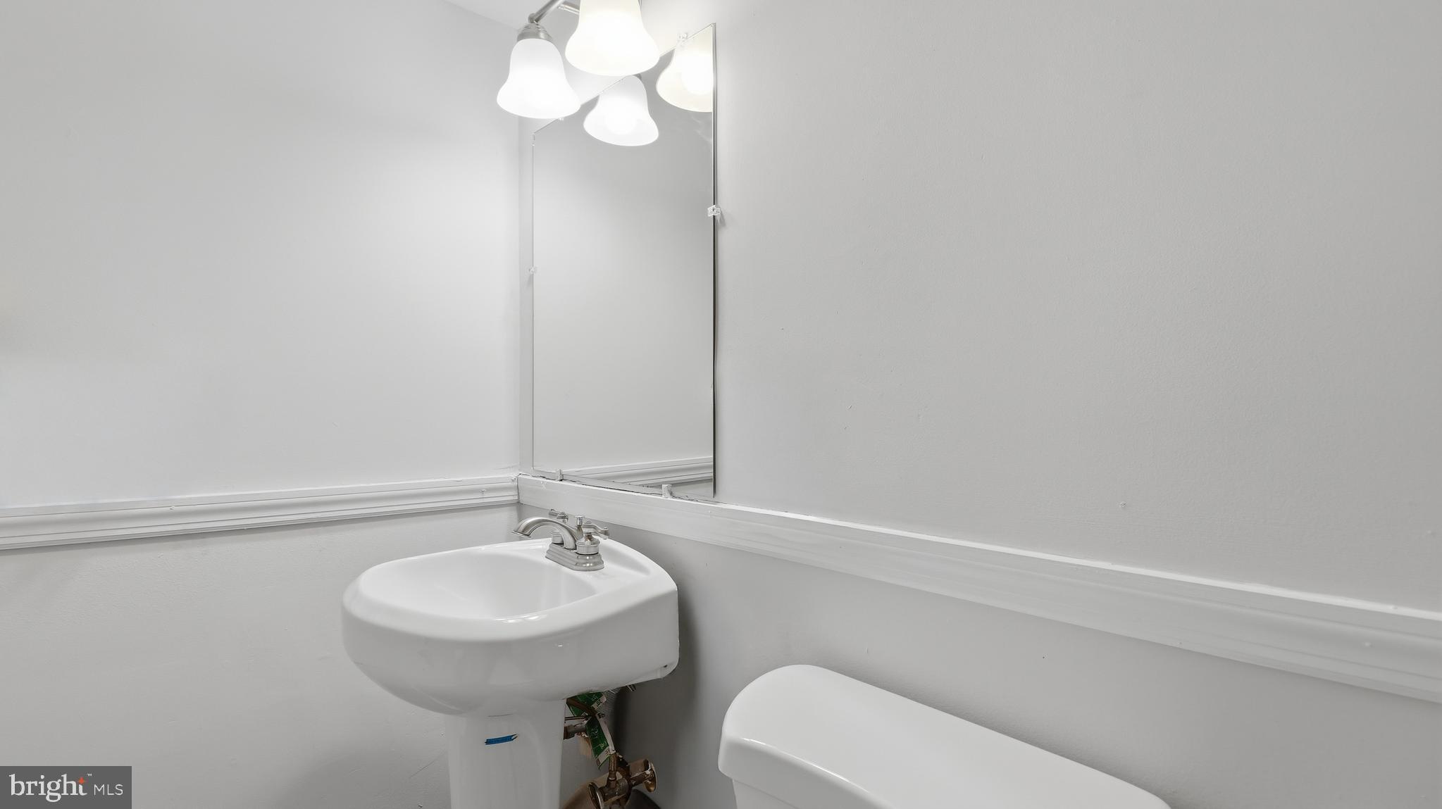 6710 Eilerson Street Clinton, MD 20735 - Photo 36 of 58 a bathroom with a sink a toilet and a mirror