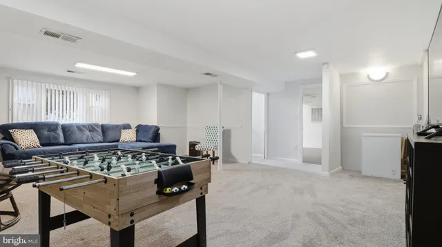 a view of a livingroom with a fireplace and a chandelier