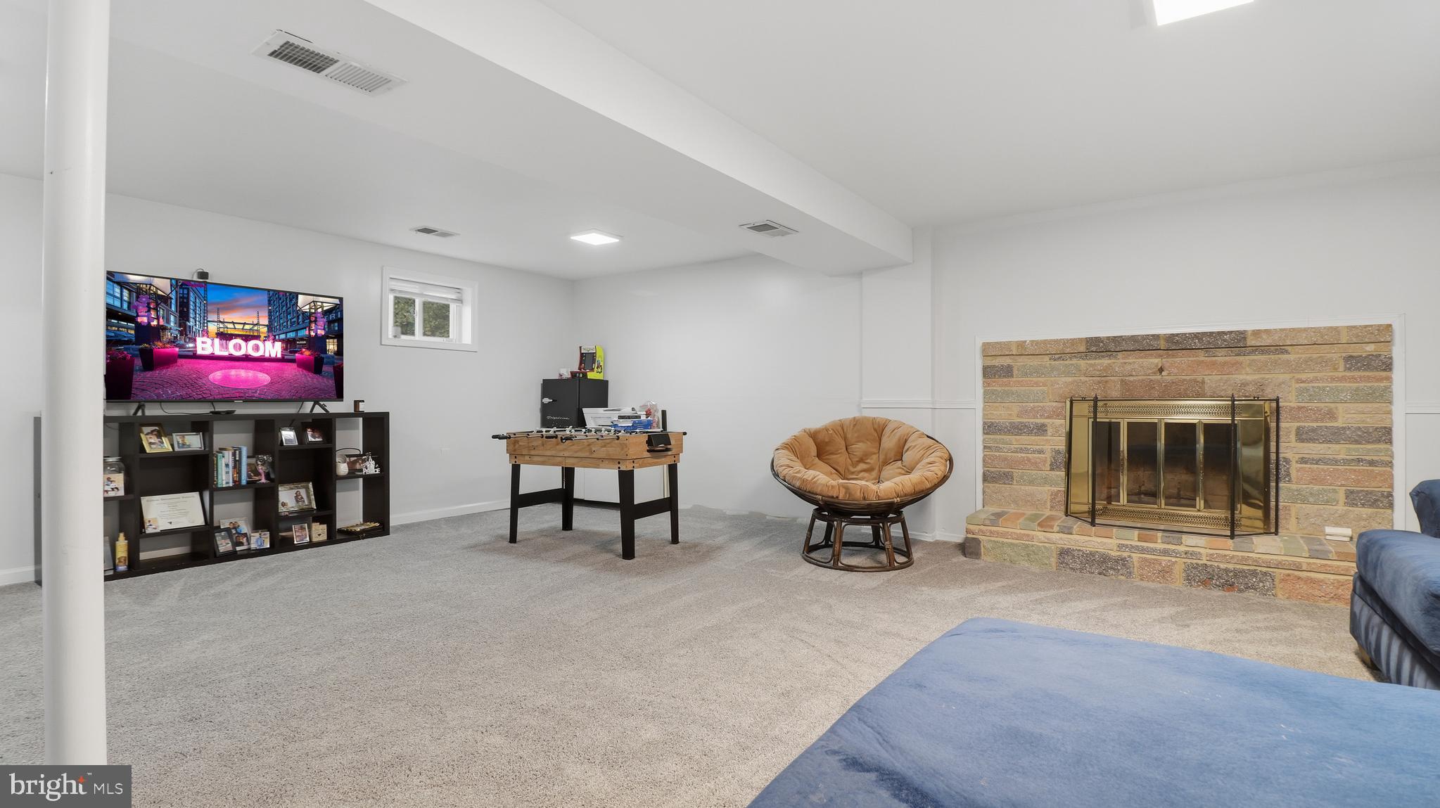 6710 Eilerson Street Clinton, MD 20735 - Photo 44 of 58 a view of a livingroom with a fireplace and a chandelier