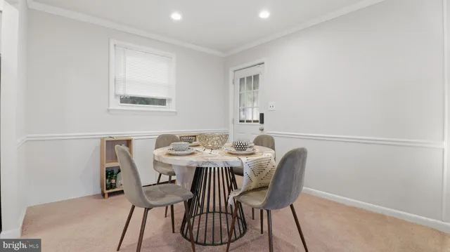 a view of a dining room with furniture and a window