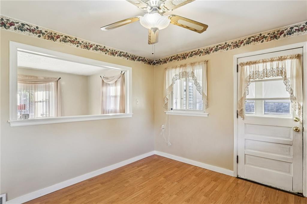 2422 Ridgewood Court New Castle, PA 16101 - Photo 13 of 50 a view of an empty room with a window and wooden floor